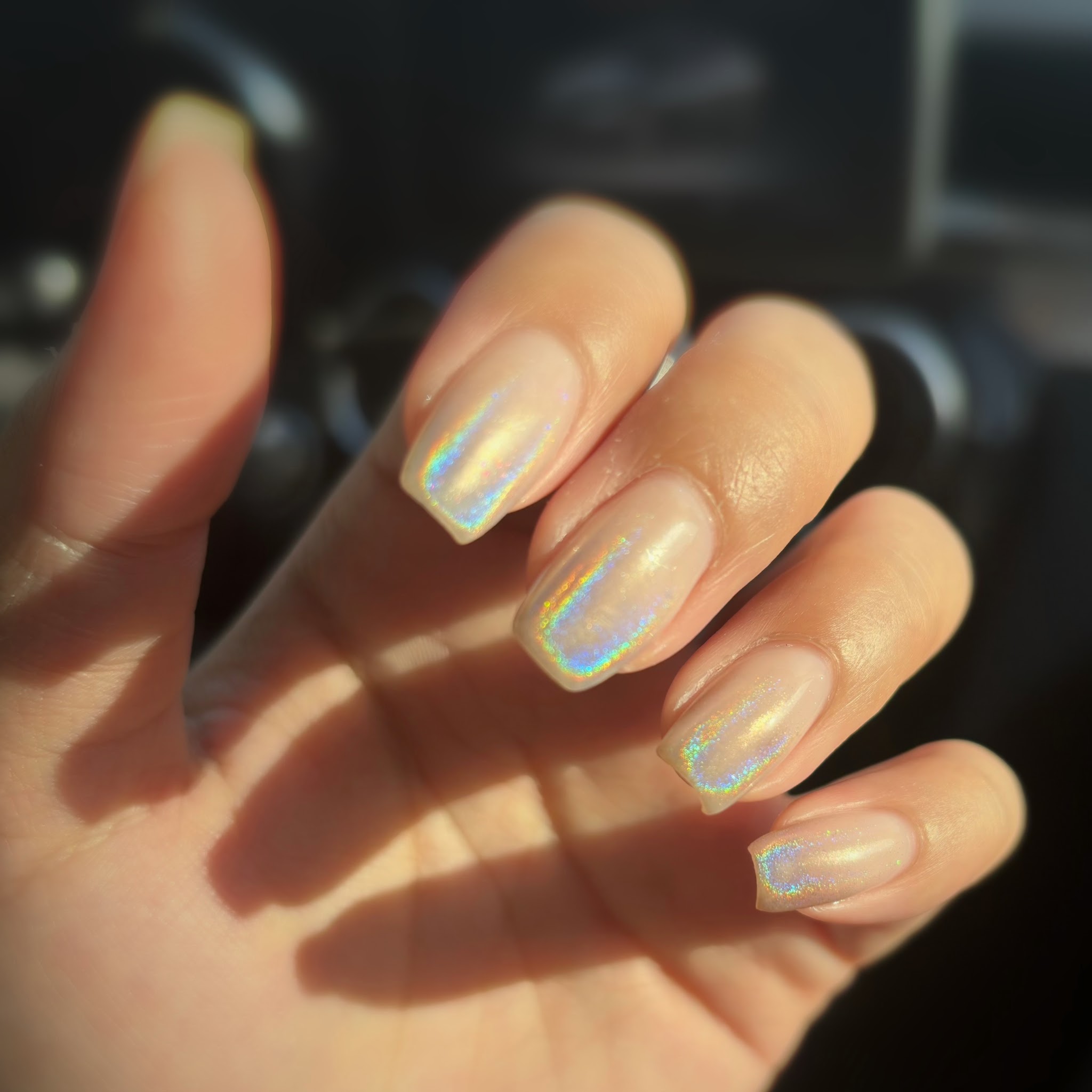 Nagels met een holografische glans in het zonlicht